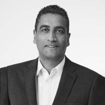Portrait of Jonathan Akeroyd, CEO of Burberry, in black and white.